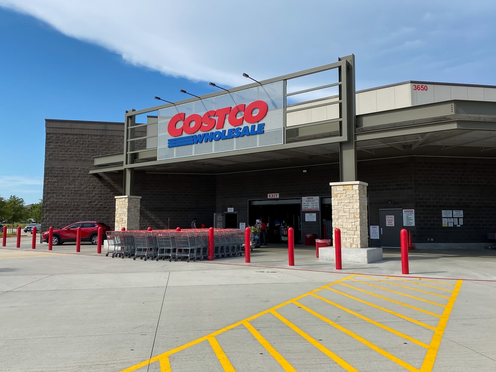 the exterior of a costco with shopping carts lined up