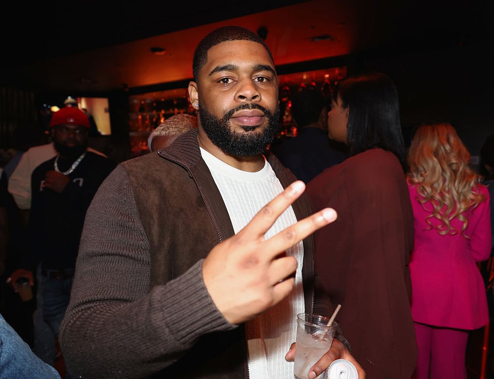 Jordan Coleman at a party giving the sideways peace sign