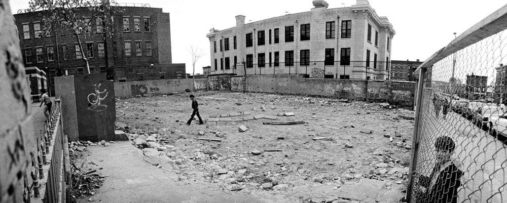 d897308a8boy-walking-through-a-vacant-lot-13th-street-1981-jpg.jpeg A boy walking through a vacant lot at 13th Street, 1981.<br/>