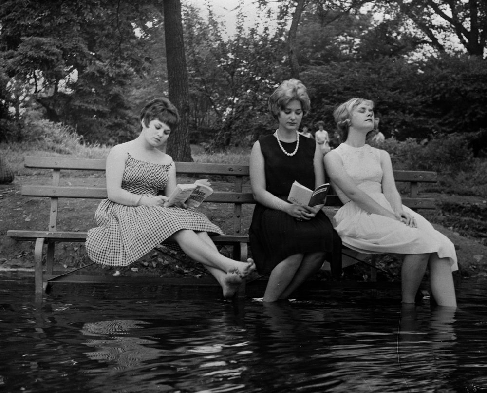 de81d5fc2.jpeg "Three women keep cool during a heat wave by moving a park bench into the water in Central Park. September 1961."