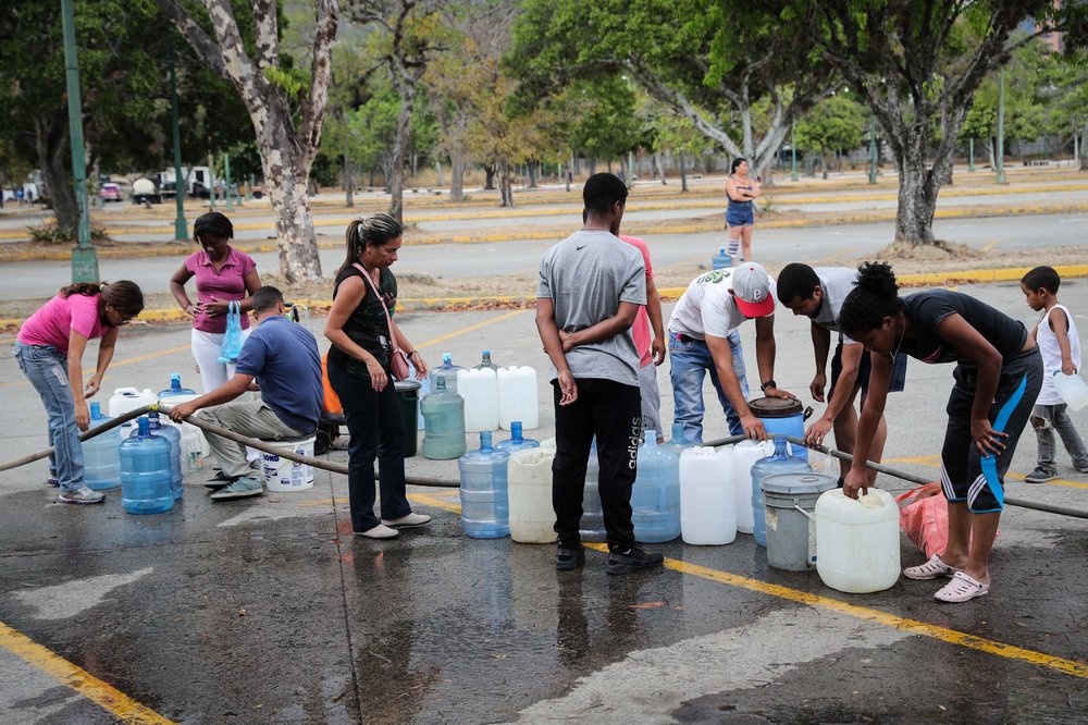 dfef540e810152404e-jpg.jpeg People collect water at the Park of the East, in Caracas, Venezuela on March 12th. <br/>(Raul Martinez/EPA-EFE/Shutterstock)
