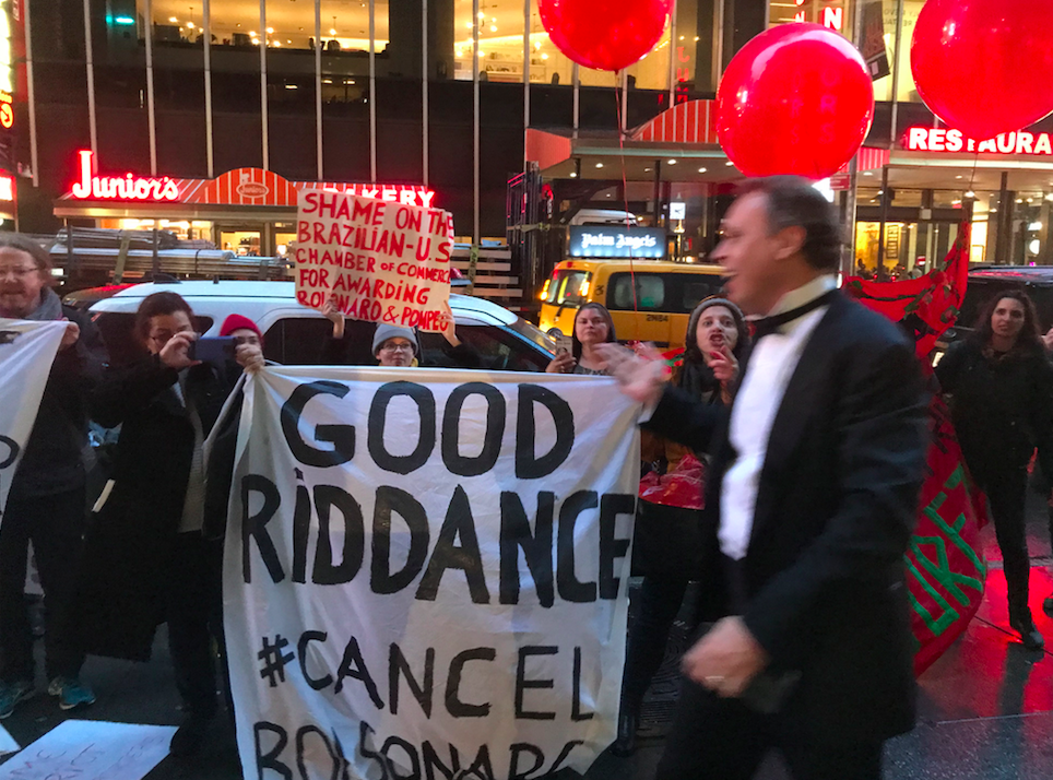 Protesters confront one of the gala attendees, who shouts back at them (Gothamist)