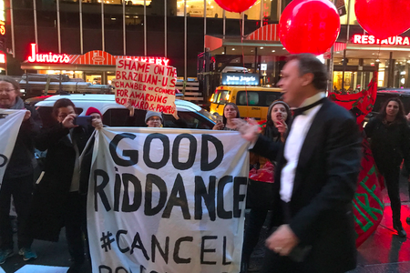 Protesters confront one of the gala attendees, who shouts back at them (Gothamist)