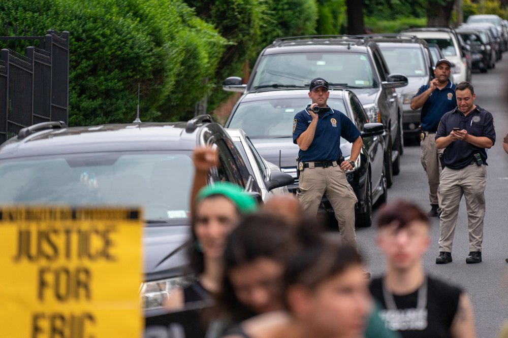 Police watch the protesters<br>