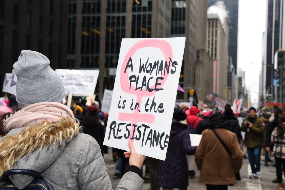 A person marching on Saturday (NameFace LLC/Shutterstock)