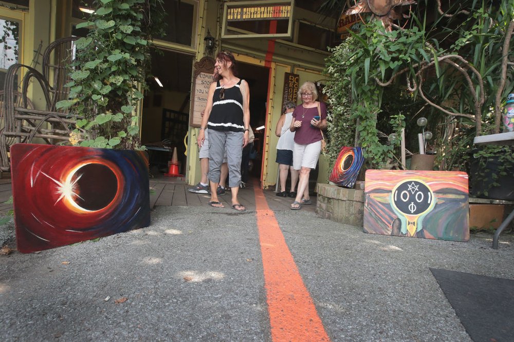 e71832aadgettyimages-835324228-jpg.jpeg Vistors walk along a line painted through town that represents the anticipated center point of the path of Mondays solar eclipse on August 18, 2017 in Makanda, Illinois.<br>