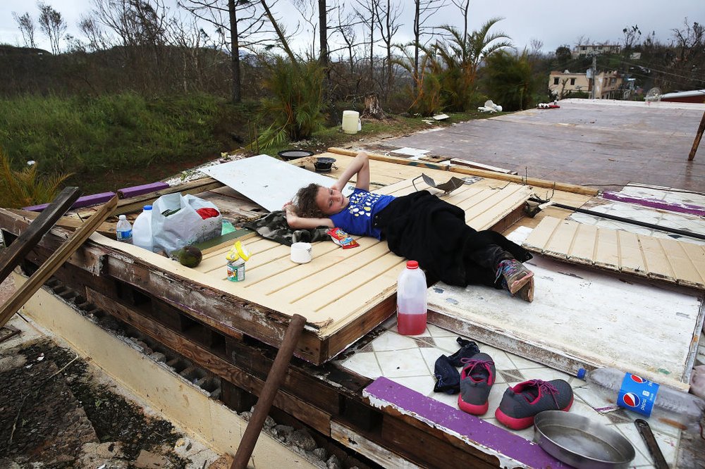 e92f8910e092517gettypuertorico11-jpg.jpeg Karlian Mercado, 7, rests on the rubble that remains of her family's home after it was blown away by Hurricane Maria. (Joe Raedle/Getty Images)