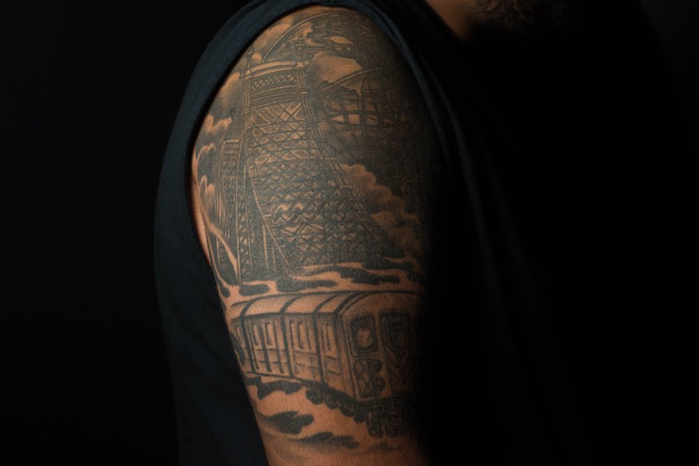 e9cf72e68ali-2-jpg.jpeg Adil Ali, of East Elmhurst, got the top of his arm covered in a Queens scene including the 7 train, the Queensboro Bridge, the Unisphere and the World's Fair Observation Towers. The tattoo was done by Jose Soto.<br>