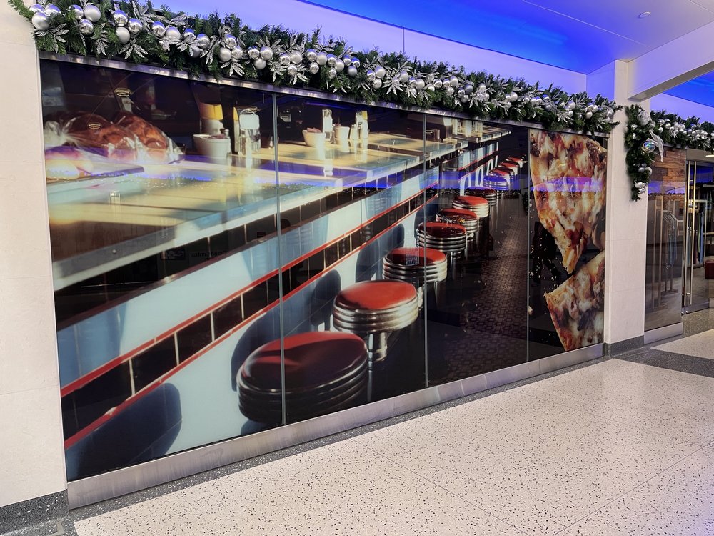 a stock image of a diner counter in a vacant storefront window at Grand Central Madison