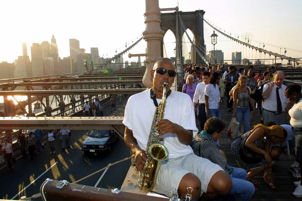 When you're commuting home on the Brooklyn Bridge with the rest of NYC during the blackout, you need some sax ( Hayden Roger Celestin / EPA/Shutterstock)