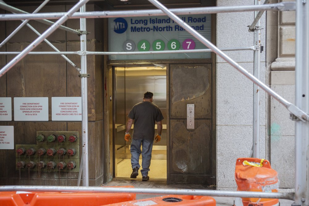 An elevator beneath construction scaffolding.