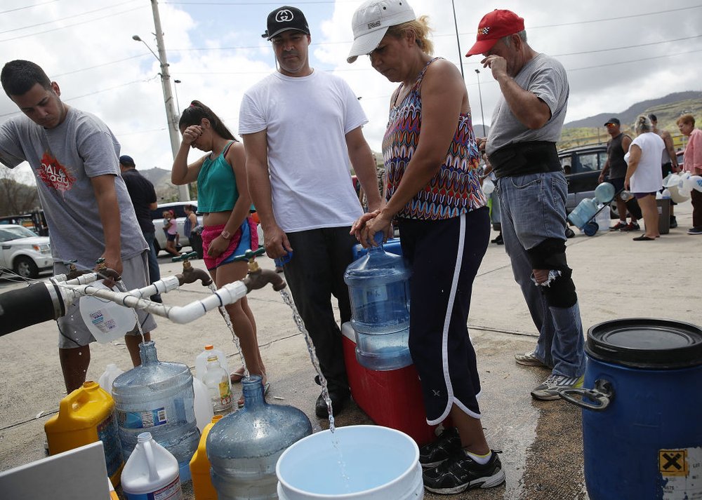 f0faf474f092617gettypuertorico14-jpg.jpeg People wait in line for water as they wait for gas, electrical and water grids to be repaired on Sunday, September 24th in Aibonito, Puerto Rico. (Joe Raedle/Getty Images)
