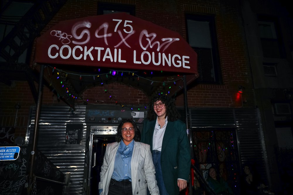 francon-3 (1).jpg Two people pose in front of Holiday Cocktail Lounge in the East Village.