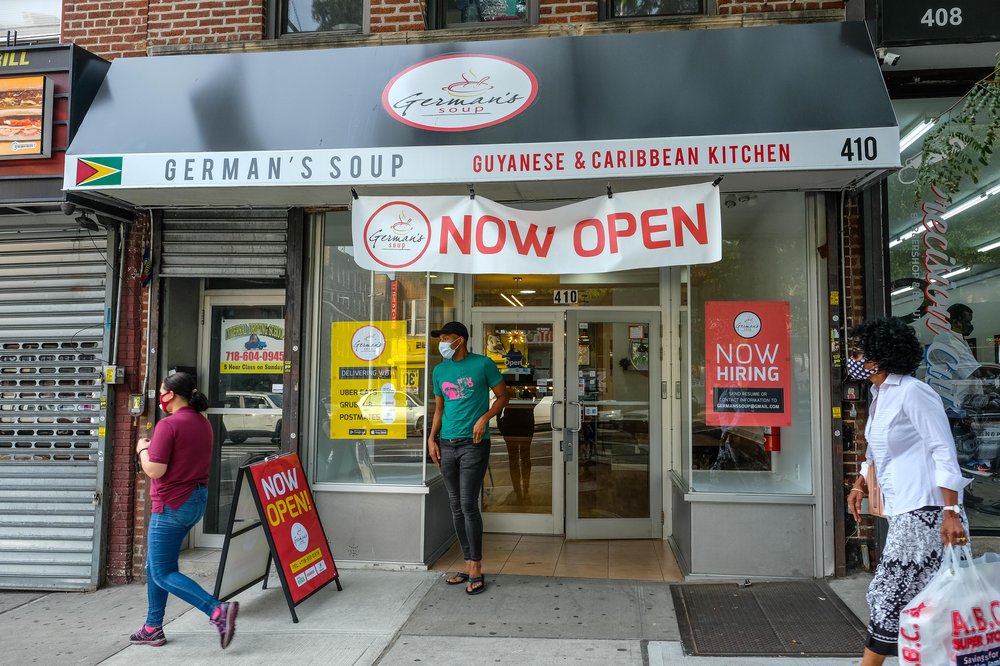 exterior with "now open" sign