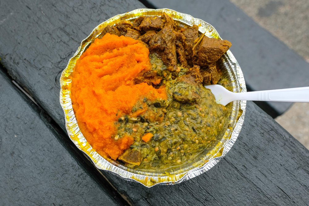 Curry Goat on Peas and Rice with Pumpkin and Callaloo ($13.50)