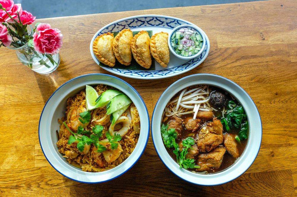 Vegan Curry Puffs ($8), Vegan Duck Noodle Soup ($19), Tom Yum Fried Rice ($23)