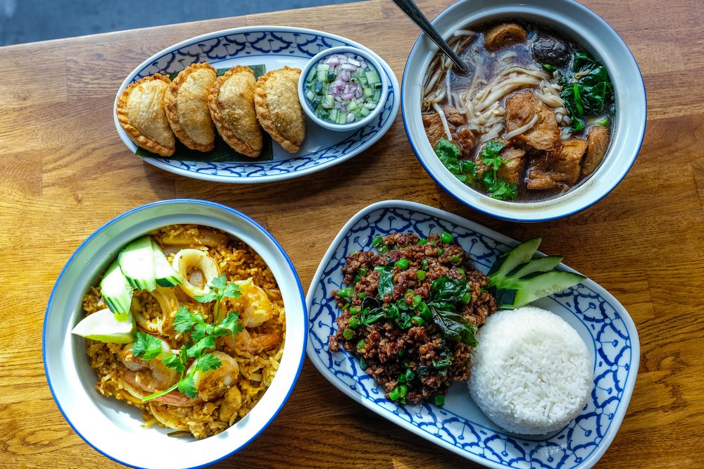 Vegan Curry Puffs ($8), Vegan Duck Noodle Soup ($19), Ground Impossible Gra Prow ($19), Tom Yum Fried Rice ($23)