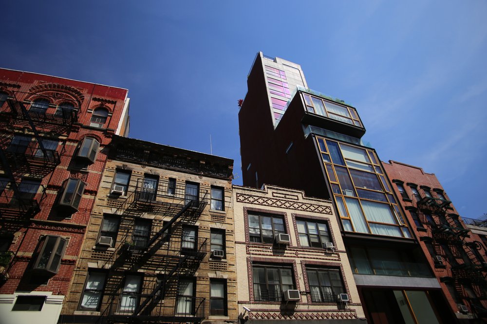 A photo of different types of housing on one city block