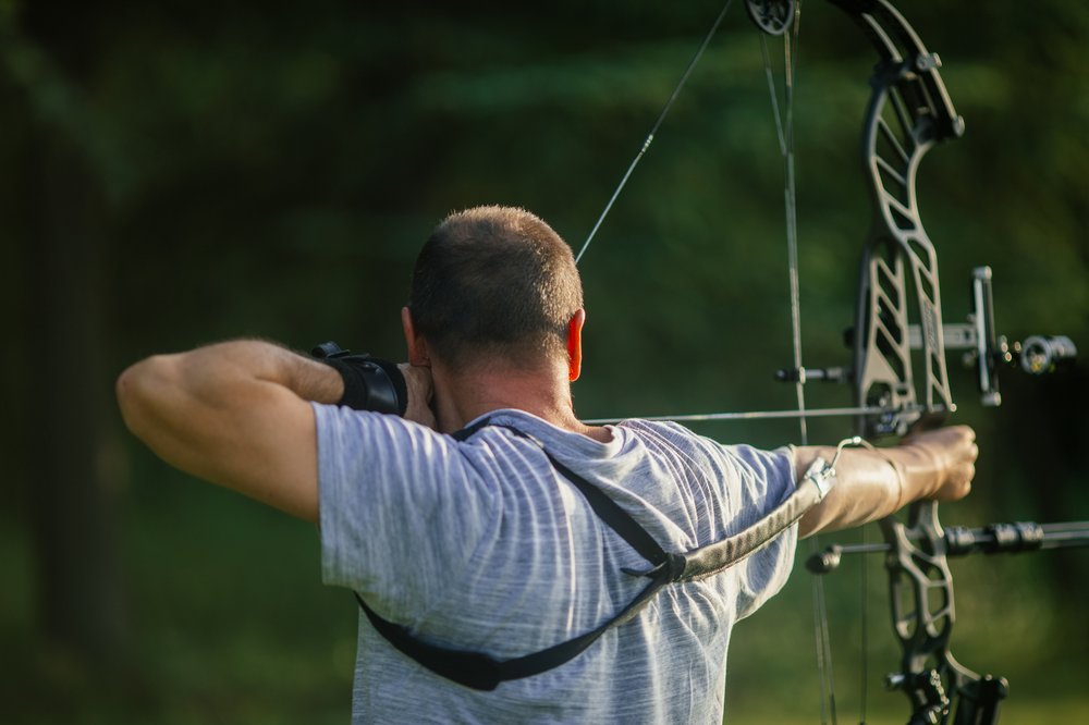 man with a bow and arrow hunting