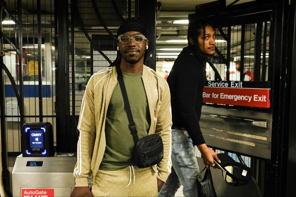 A man stands in front of subway emergency exit.