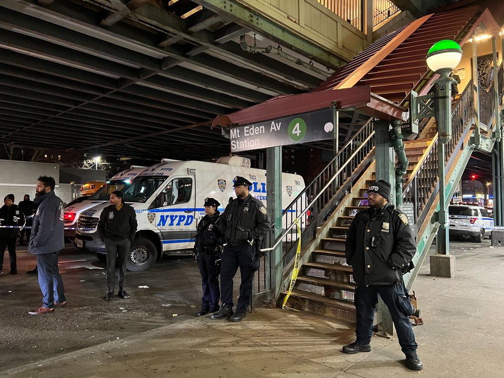 Officers stand near the entrance to the Bronx subway platform where a shooting occurred on Monday afternoon.