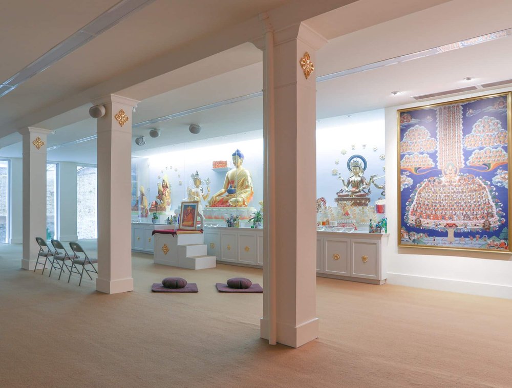 A meditation room with a mural in the background