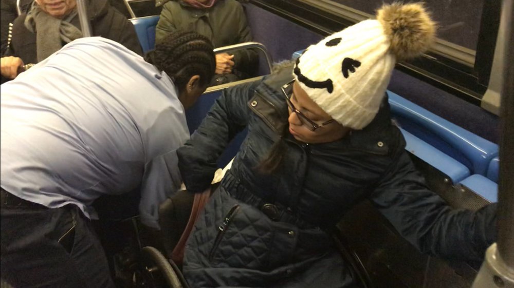 Katherine Valdez gets buckled into a NYC Transit bus.