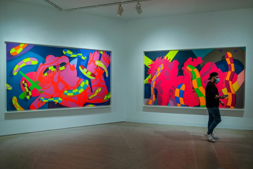 KAWS Brooklyn Museum Neon colored abstract paintings. Inside the KAWS exhibit at Brooklyn Museum