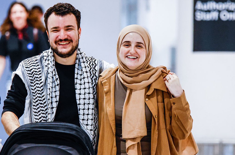 Mahmoud Khalil with his wife and newborn at the airport