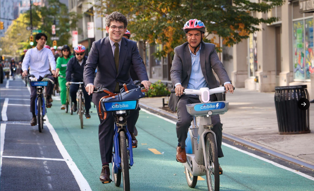 Two men ride Citi Bikes.