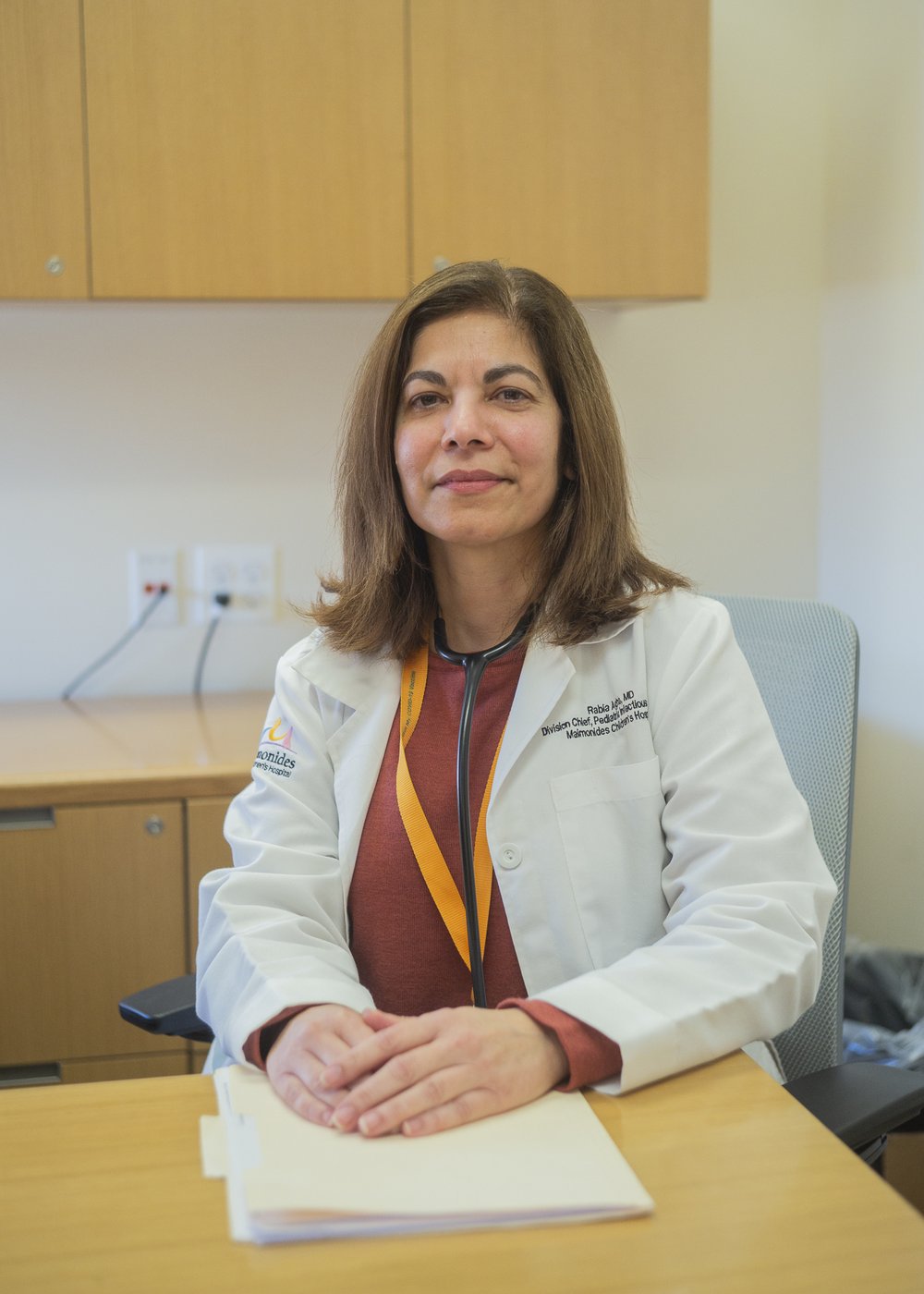 A doctor sits on her office.