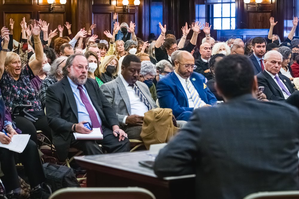 Participants seen cheering during an NYC City Council hearing about the proposed changes to the city’s administrative code and municipal retirees' health care benefits, Jan. 9, 2023.