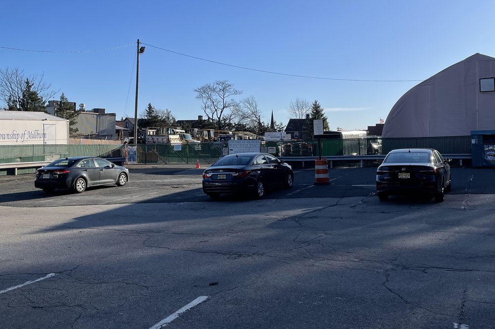 A parking lot with a few cars parked.