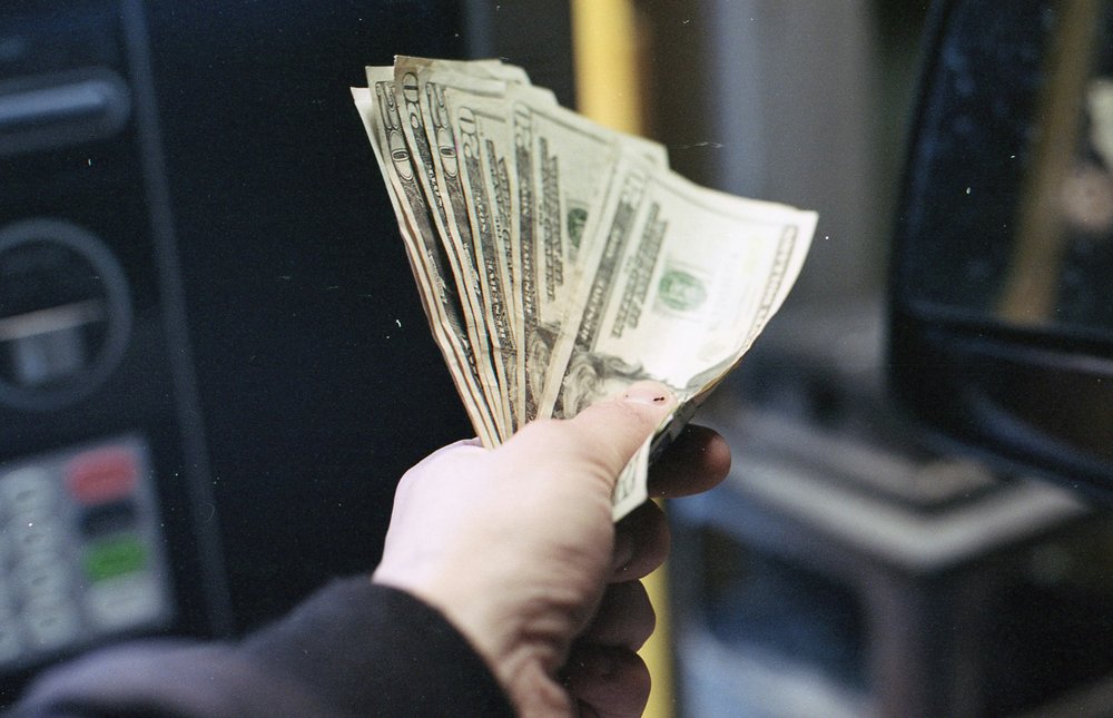 Person holding cash.