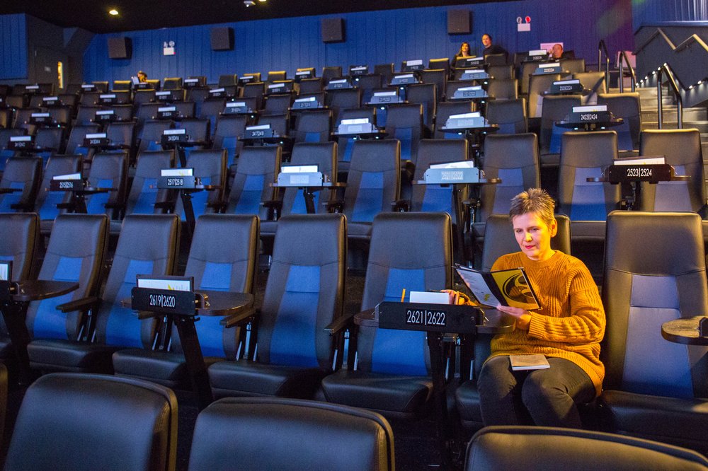 A person sits in a movie theater