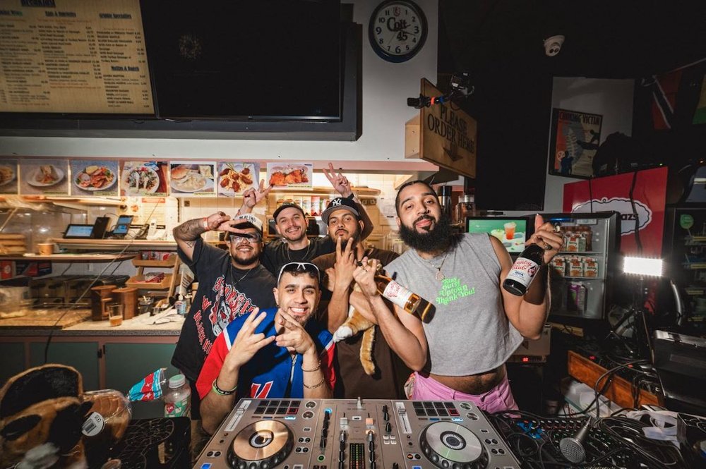 A group of people at a party in a bodega.