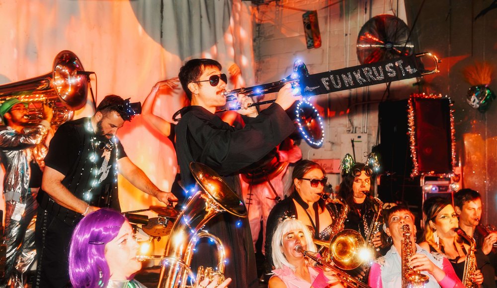 A musician plays an instrument onstage.