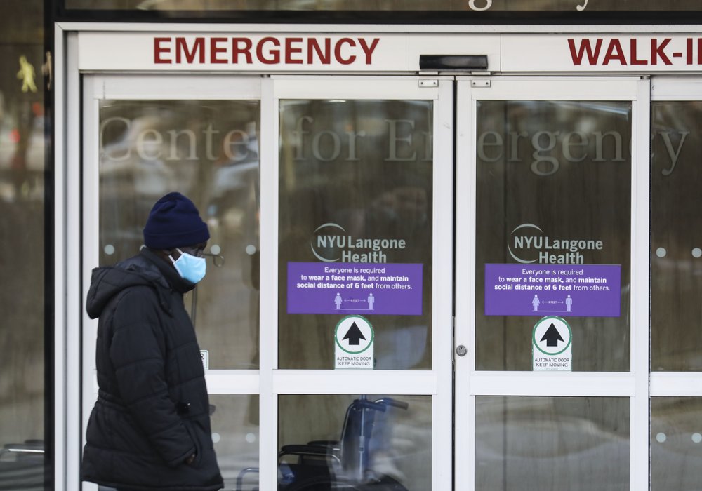 A pedestrian walks past the entrance of an emergency room of a hospital in New York City, Dec. 13, 2021