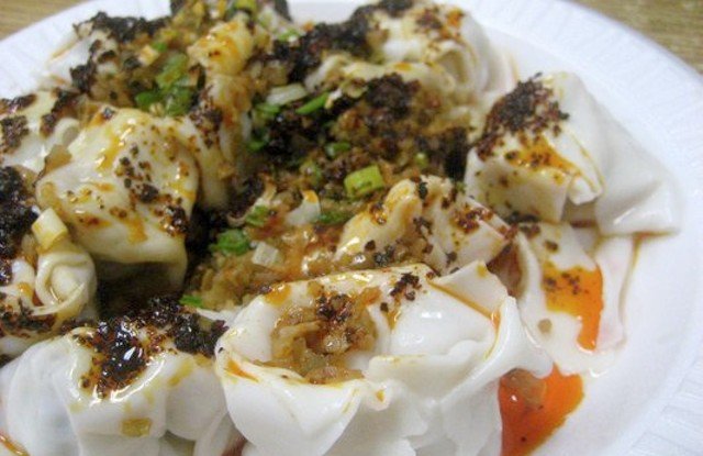 oct2111whitebear.jpg Best Spicy Wonton: White Bear: This teeny-tiny Flushing storefront with a ripped awning serves mind-blowingly good Northern Chinese-style dumplings. The plump little chili oil wontons, stuffed with minced pork and cabbage, arrive drowning in a fiery red oil and topped with pickled vegetables, ground chilis and scallions. Your taste buds will be shocked and awed. Expect Styrofoam plates, tiny tables, and come prepared to pointâEnglish isn't the first order of business here.135-02 Roosevelt Avenue, #5 // (718) 961-2322