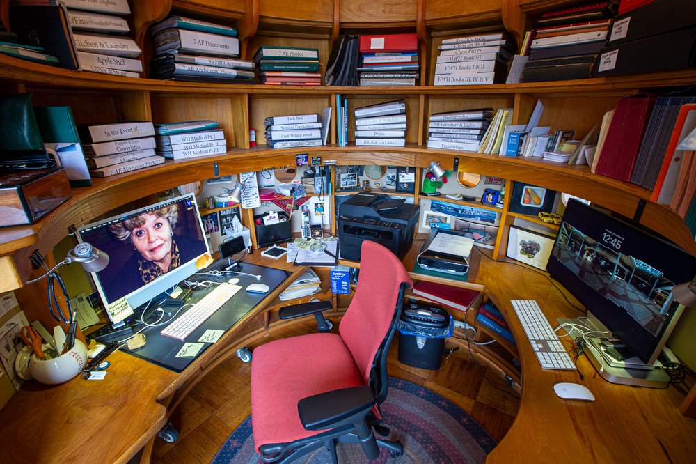 A look inside an office with shelves and a computer