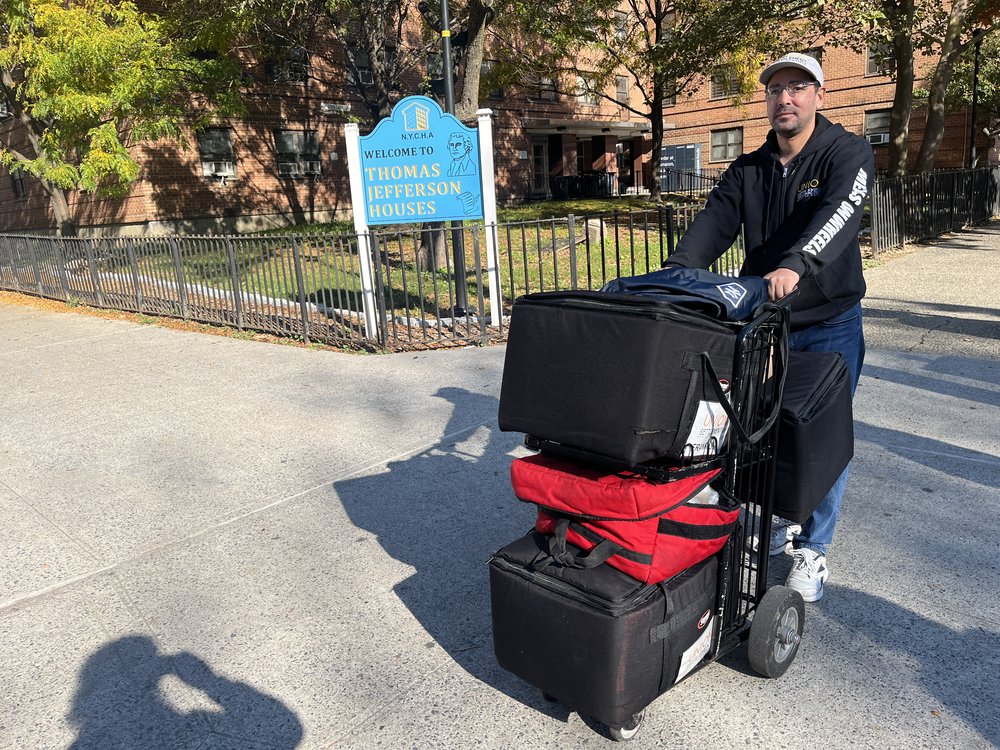 Omi Perez delivers food to homebound seniors for a Meals on Wheels program based out of Union Settlement in Harlem.