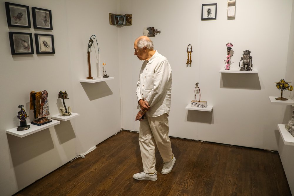 outsider-32.jpg a man dressed in white looks at art