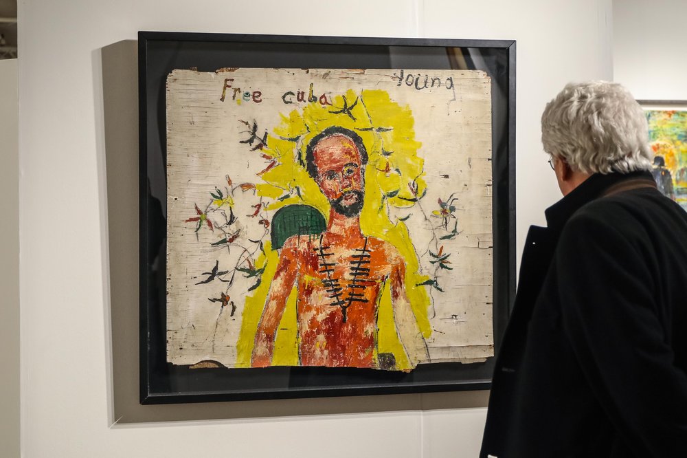 outsider-68.jpg a man looks at a painting