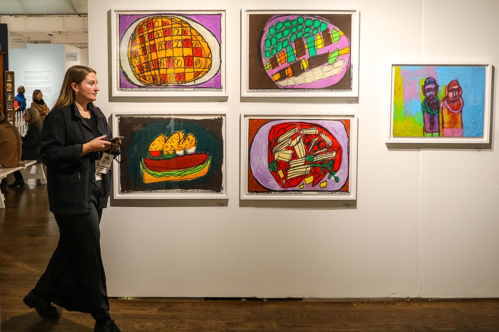 outsider-77.jpg A person walks past paintings of food