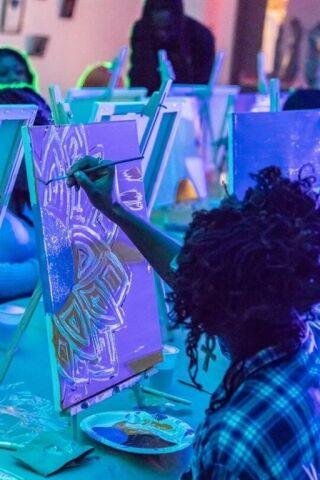 A young person paints.