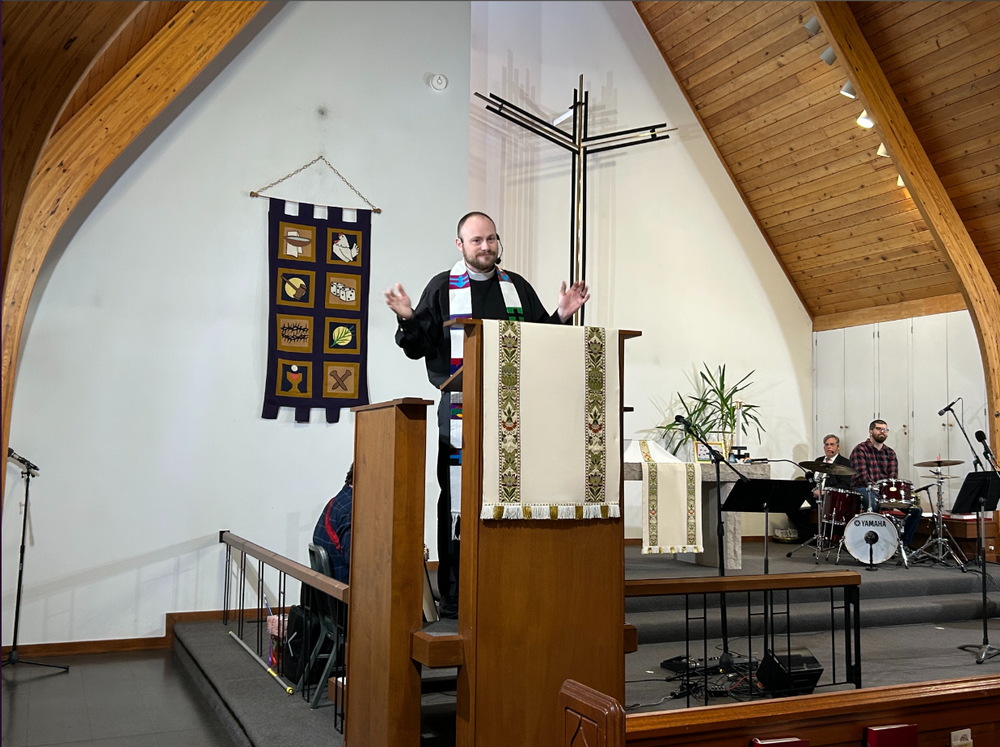 A pastor delivers prayer service.