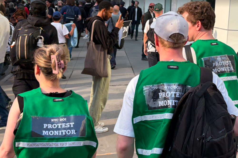 NYC Department of Investigations monitors marching alongside protesters in Manhattan Tuesday.