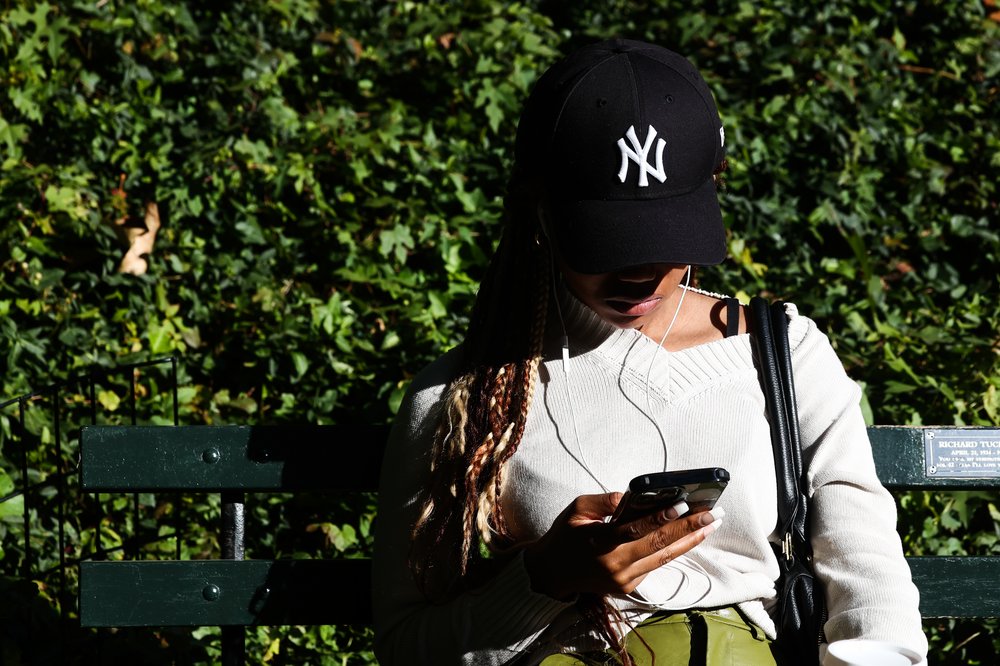 A woman sits in Central Park on Oct. 22, 2022.