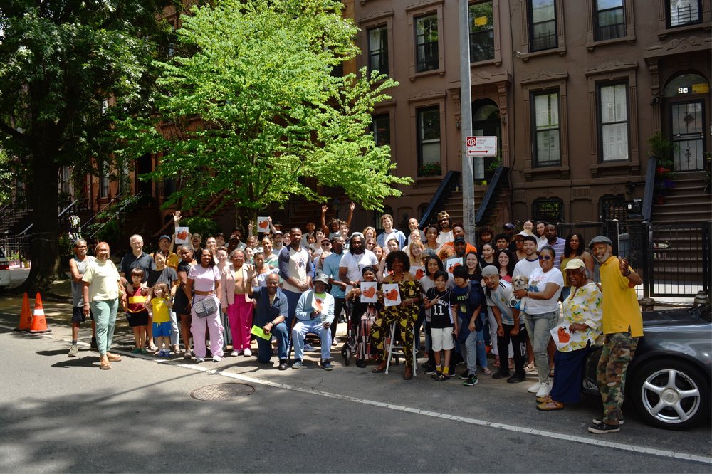 Some residents of the two blocks pose for a photo on June 9, 2024.