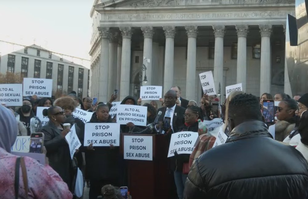 A rally with women holding signs that say "Stop prison sex abuse" and similar messages.